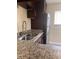 Kitchen features granite countertops, stainless steel sink, and dark wood cabinets at 2802 N Powers Dr # 18, Orlando, FL 32818