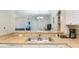Kitchen with double sink, breakfast bar and view into living area at 3177 Feltrim Pl # 104, Kissimmee, FL 34747