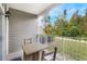 Covered patio with hanging planters and scenic backyard view at 3177 Feltrim Pl # 104, Kissimmee, FL 34747