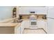 White kitchen with stainless steel appliances and light countertops at 3177 Feltrim Pl # 104, Kissimmee, FL 34747