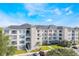 Modern apartment building with ample parking and lush landscaping at 3177 Feltrim Pl # 104, Kissimmee, FL 34747