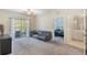 Spacious living room with sliding glass doors leading to a balcony at 3177 Feltrim Pl # 104, Kissimmee, FL 34747
