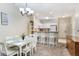 Bright dining area with white table and chairs adjacent to the kitchen at 3177 Feltrim Pl # 104, Kissimmee, FL 34747