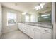 Elegant bathroom with double vanity, granite countertop, and large mirror at 3303 Kayak Way, Orlando, FL 32820