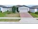 House with gray siding, brick driveway, and small front yard at 416 Mckenna Dr, Winter Haven, FL 33881
