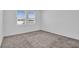 Spacious bedroom with neutral carpeting and two windows at 416 Mckenna Dr, Winter Haven, FL 33881