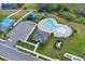 Community pool and clubhouse with surrounding parking lot at 416 Mckenna Dr, Winter Haven, FL 33881