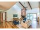 Bright living room with hardwood floors, high ceilings, and a brick fireplace at 4834 Hall Rd, Orlando, FL 32817