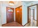 Inviting entryway with brick flooring, wood door, and built-in storage at 4834 Hall Rd, Orlando, FL 32817