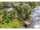 Aerial view of house on waterfront lot with private dock and lush landscaping at 4834 Hall Rd, Orlando, FL 32817