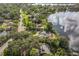 Aerial view showcasing a lakefront property with a pool and lush landscaping at 4834 Hall Rd, Orlando, FL 32817