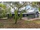 Dark gray house with mature landscaping and a brick walkway at 4834 Hall Rd, Orlando, FL 32817
