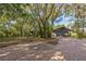 Exterior view of a home with a paved driveway and mature landscaping at 4834 Hall Rd, Orlando, FL 32817