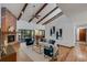 Spacious living room with vaulted ceilings, brick fireplace, and hardwood floors at 4834 Hall Rd, Orlando, FL 32817