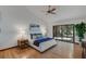 Bright bedroom with wood floors, a ceiling fan, and access to a patio at 4834 Hall Rd, Orlando, FL 32817