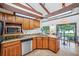 Kitchen with granite countertops, wood cabinets, and stainless steel appliances at 4834 Hall Rd, Orlando, FL 32817