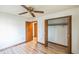 Bedroom with wood flooring and a double door closet at 4834 Hall Rd, Orlando, FL 32817