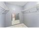 Large walk-in closet with wire shelving and mirror at 5208 Via Hacienda Cir # 201, Orlando, FL 32839
