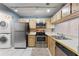 Kitchen with stainless steel appliances and wood cabinets at 5208 Via Hacienda Cir # 201, Orlando, FL 32839