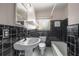 Bathroom with black and white tile and pedestal sink at 811 W Winter Park St, Orlando, FL 32804