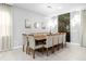 Spacious dining room with large wooden table and seating for twelve at 8881 Qin Loop, Kissimmee, FL 34747