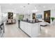 Modern kitchen with island, stainless steel appliances, and granite countertops at 8881 Qin Loop, Kissimmee, FL 34747