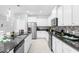 White kitchen with stainless steel appliances and dark countertops at 8881 Qin Loop, Kissimmee, FL 34747