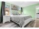 Bedroom with a queen-size bed and light green walls at 8881 Qin Loop, Kissimmee, FL 34747