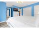 Spacious bedroom with white dresser, TV, and blue walls at 8881 Qin Loop, Kissimmee, FL 34747