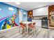 Small kitchenette with white cabinets and Mario theme at 8881 Qin Loop, Kissimmee, FL 34747