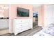 Bedroom with white dresser and large TV at 8881 Qin Loop, Kissimmee, FL 34747