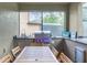 Outdoor kitchen with grill, sink, and bar seating at 8881 Qin Loop, Kissimmee, FL 34747
