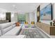 Spacious living room featuring a large TV, comfortable seating, and access to a pool at 8881 Qin Loop, Kissimmee, FL 34747