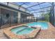 Screened pool and spa with brick deck at 8881 Qin Loop, Kissimmee, FL 34747
