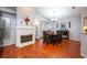 Dining room with a wooden table and chairs, fireplace, and hardwood floors at 972 Piedmont Oaks Dr, Apopka, FL 32703