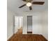 Bright bedroom with wood-look floors, ceiling fan and access to another room at 1419 Ne 21St St, Ocala, FL 34470