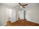 Spacious bedroom with wood-look floors, ceiling fan and access to bathroom at 1419 Ne 21St St, Ocala, FL 34470