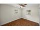 Well-lit bedroom with wood-look floors and ceiling fan, two windows with blinds at 1419 Ne 21St St, Ocala, FL 34470