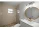 Modern bathroom with updated vanity, a large mirror, and stone shower at 1419 Ne 21St St, Ocala, FL 34470