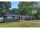 Newly renovated home with red door and landscaped yard at 1419 Ne 21St St, Ocala, FL 34470