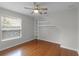 Bright bedroom featuring hardwood floors and built-in shelving at 1869 Merlot Dr, Sanford, FL 32771