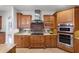 Modern kitchen with gas cooktop, stainless steel appliances, and tile backsplash at 1869 Merlot Dr, Sanford, FL 32771
