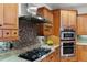 Modern kitchen with gas cooktop, stainless steel appliances, and tile backsplash at 1869 Merlot Dr, Sanford, FL 32771