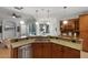 Open kitchen with breakfast bar, granite counters, and pool view at 1869 Merlot Dr, Sanford, FL 32771