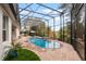Freeform pool with brick decking and screened enclosure at 1869 Merlot Dr, Sanford, FL 32771