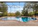 Inviting screened pool with brick pavers and tranquil water feature at 1869 Merlot Dr, Sanford, FL 32771