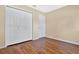 Bedroom with double door closet and wood-look floors at 3629 Peaceful Pl, Orlando, FL 32810