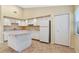 White kitchen with ample cabinet space and an island at 3629 Peaceful Pl, Orlando, FL 32810