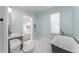 Modern bathroom with a freestanding tub, marble flooring, and a stylish sink at 727 N Grandview Ave, Daytona Beach, FL 32118