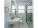 Clean bathroom with a pedestal sink, toilet, and a walk-in shower at 727 N Grandview Ave, Daytona Beach, FL 32118